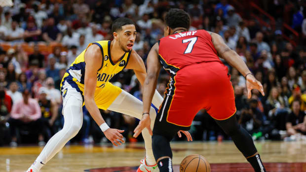 Pacers guard Tyrese Haliburton dribbles around Heat guard Kyle Lowry.